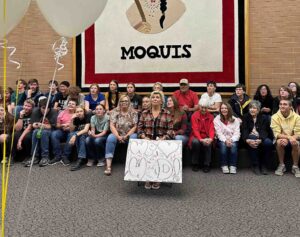 Secretary of the Year Derlynne Brooks, students, dear friends and family watch a slideshow highlighting Brooks’ nearly 40 years of service to the school during the awards ceremony honoring her on October 25, 2023. Nancy Goude